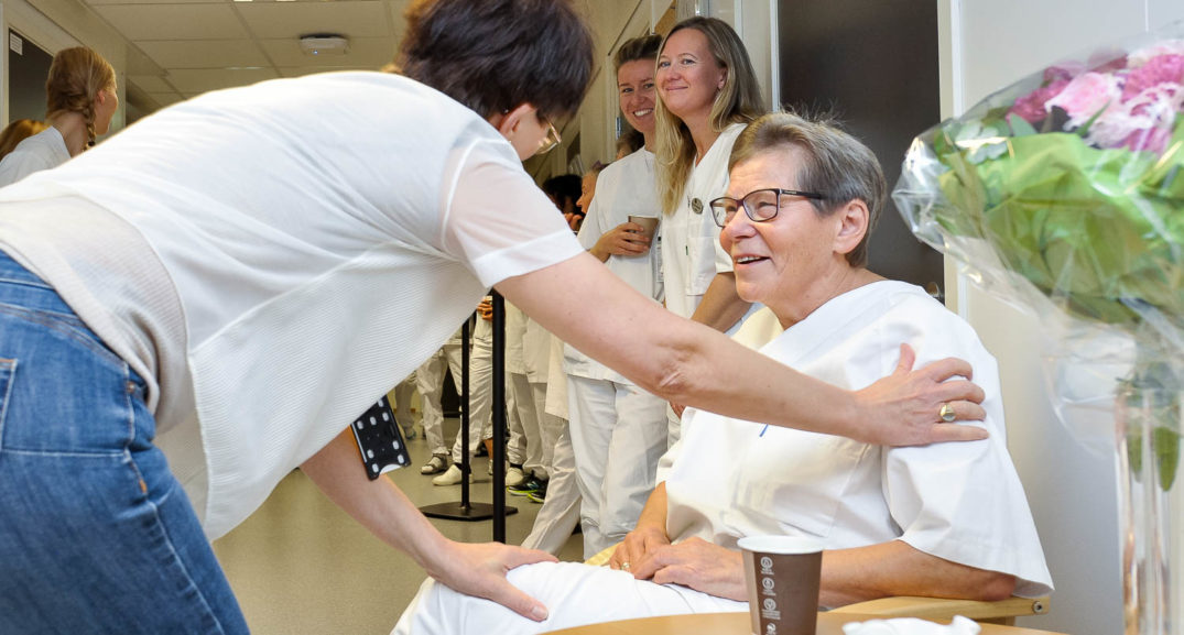 En kvinne som gir en mann et papir