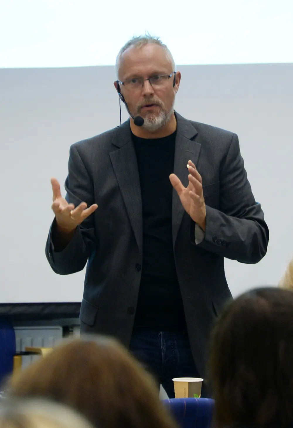 En mann iført dress og briller