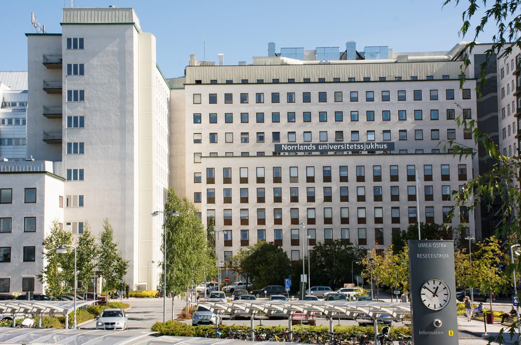 En stor bygning med en klokke foran seg