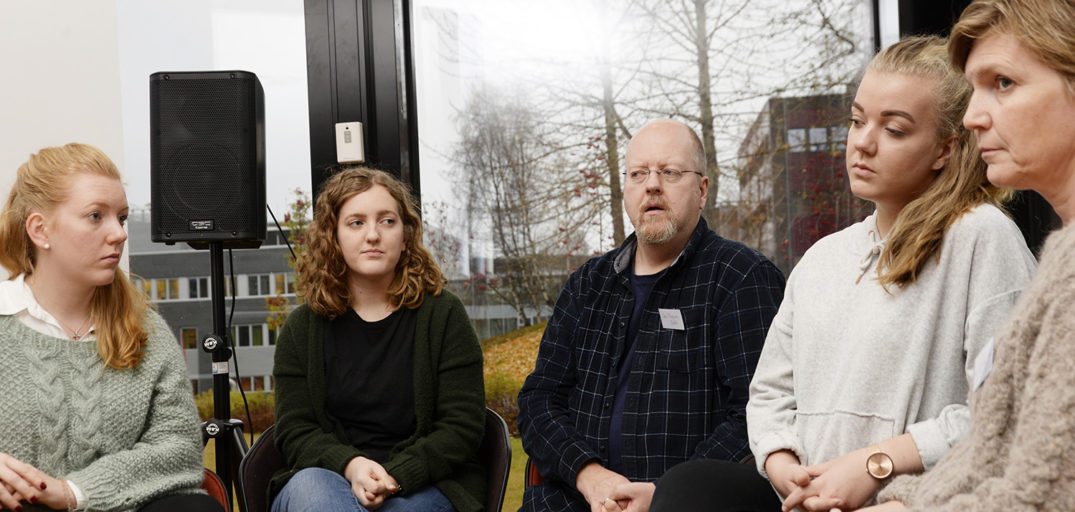 En gruppe mennesker som sitter i et rom