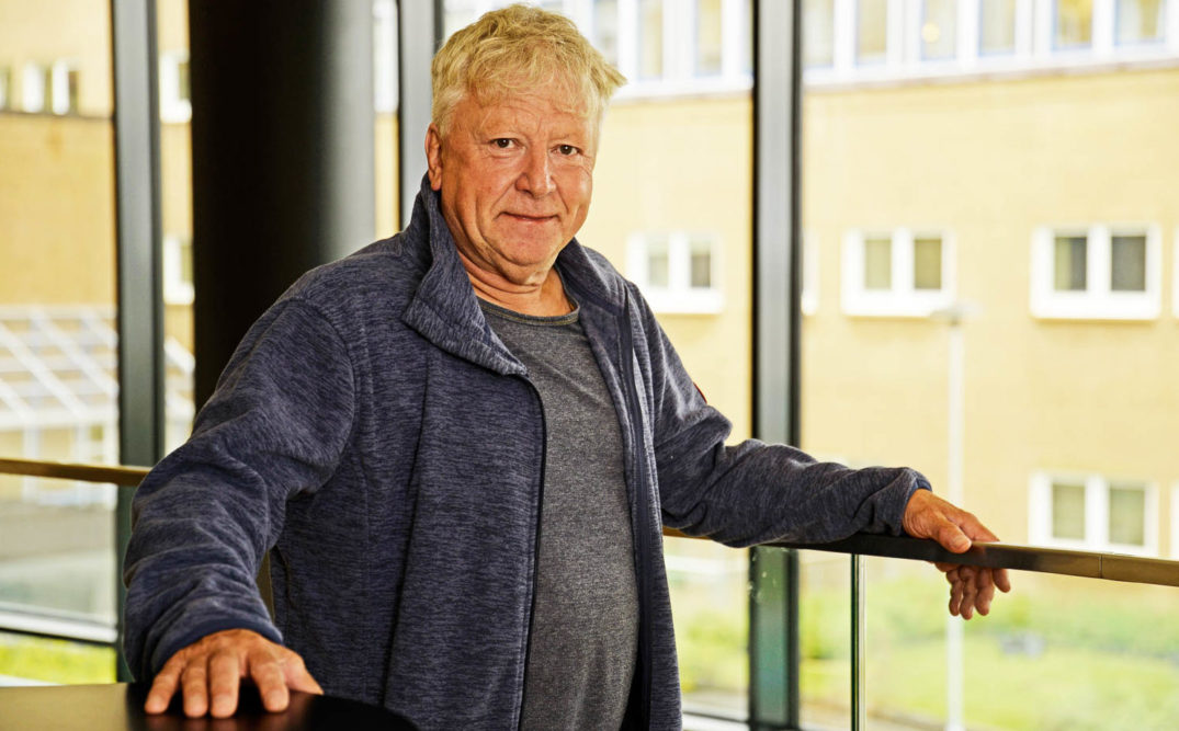 En mann som lener seg mot et vindu