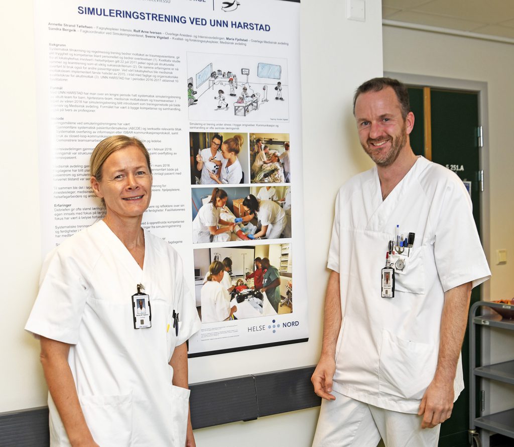 En mann og en kvinne står foran en plakat