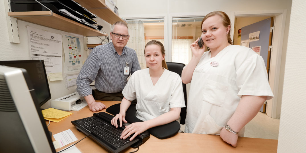 Klinikksjef Bjørn-Yngvar Nordvåg i Nevro-, ortopedi og rehabiliteringsklinikken roser jobben som helsesekretærene Ine Charlotte Olsen og Christina Nilsen gjør for å få pasienter til å møte til avtalte timer gjennom telefonkontakt og SMS-varsling. Foto: Jan Fredrik Frantzen