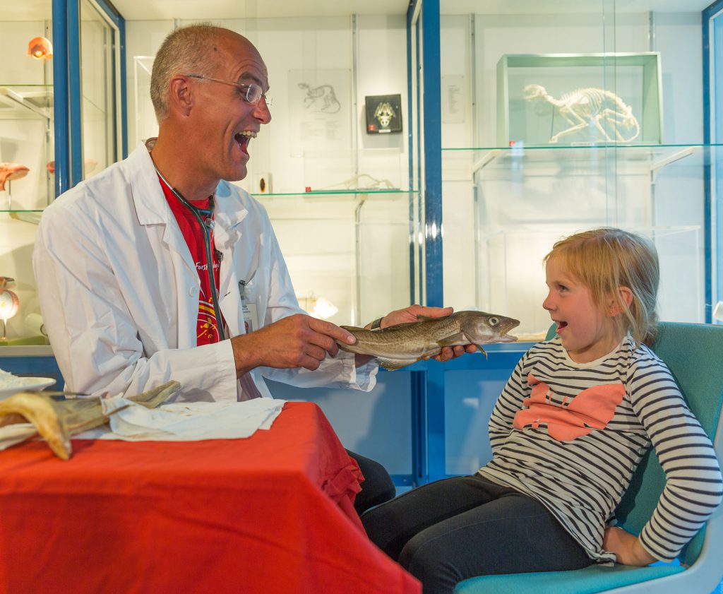 En mann og en jente som holder en fisk
