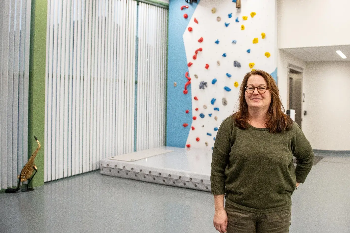 Kvinne n som står foran en klatrevegg