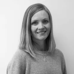 En kvinne som smiler til kameraet