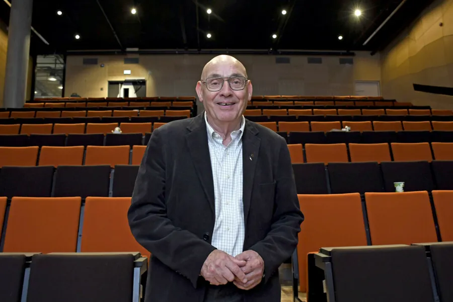En mann som står foran et stort tomt auditorium