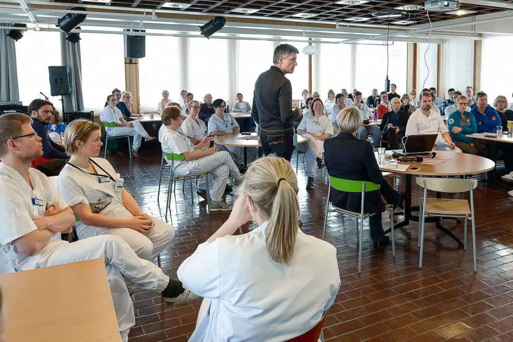 En gruppe mennesker som sitter i et rom