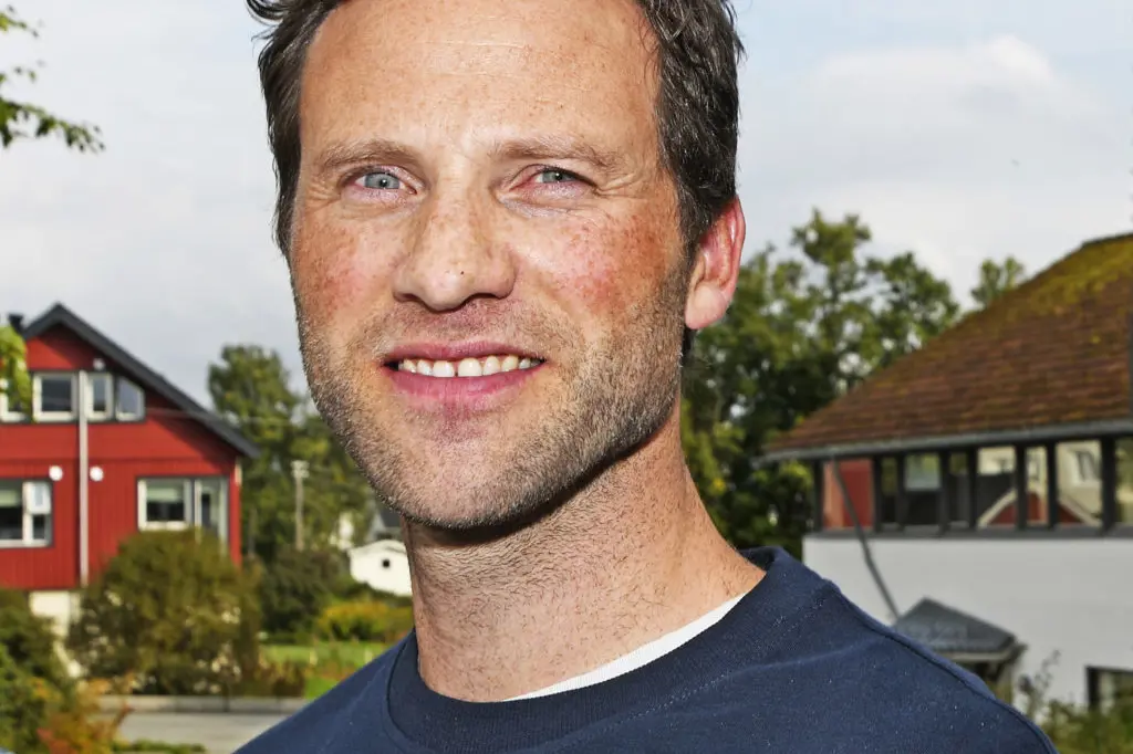 En mann som smiler til kameraet