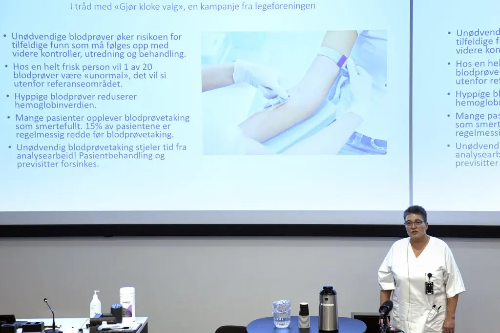 En mann som står foran en stor skjerm