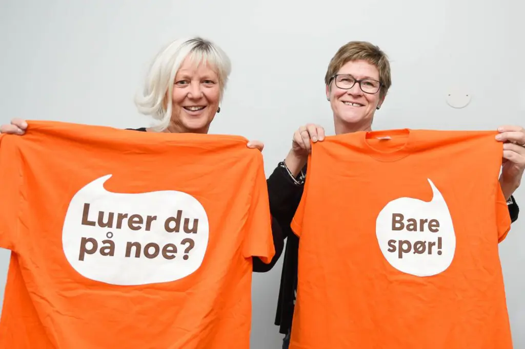 En mann og kvinne som holder opp et skilt