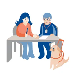 Dame og mann som sitter og snakker i FM-utstyr, førerhund nedenfor bord